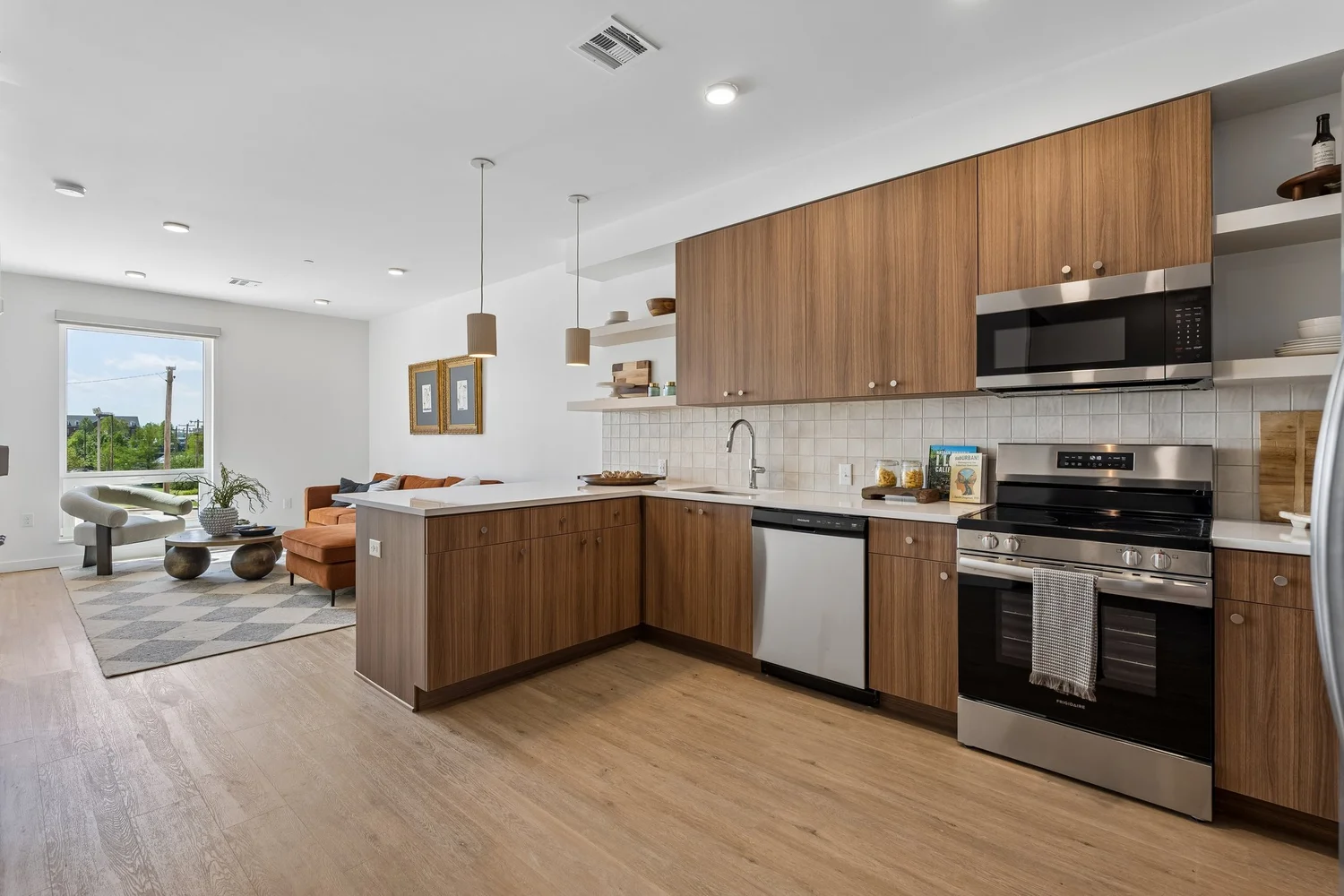 Model unit kitchen open to the living area in an Oklahoma apartment community