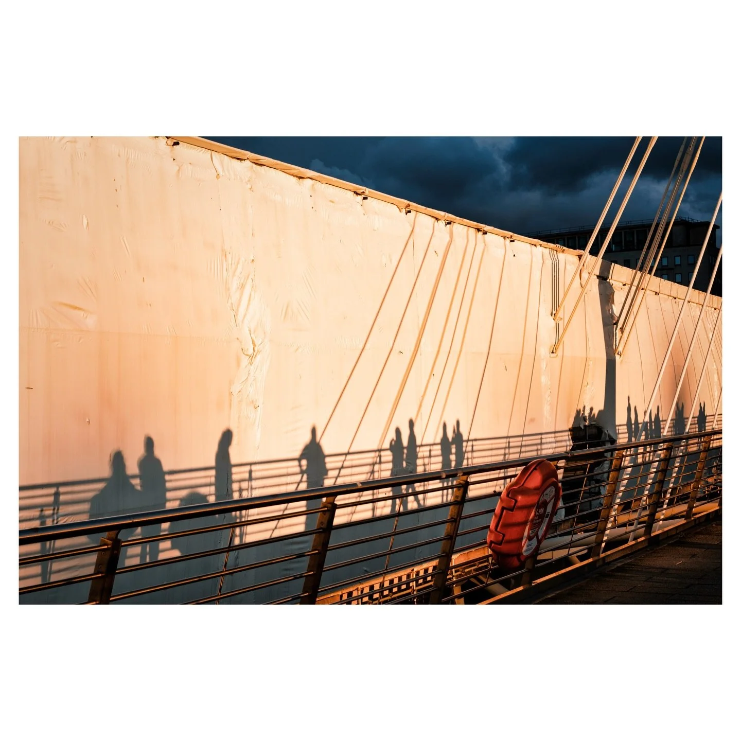 Unforgettable Fire.
Golden Jubilee Bridges, London. 2025.
.
I&rsquo;ll never forget this particular afternoon light. The bridge has been shrouded in white tarpaulin for some months now, and this acts almost as a cinema screen with a low afternoon sun