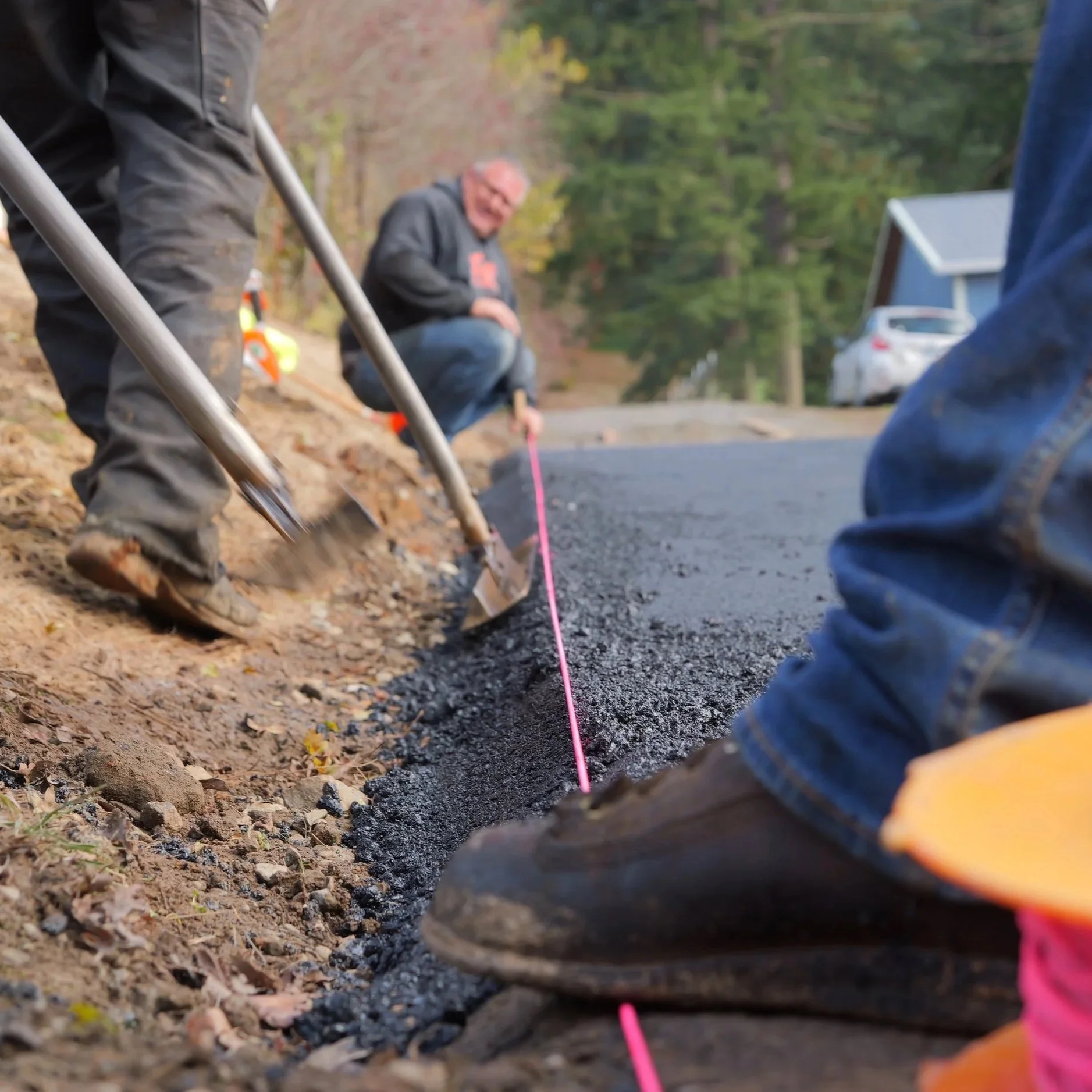 Pulling a string-line for making sure it is a good quality asphalt driveway