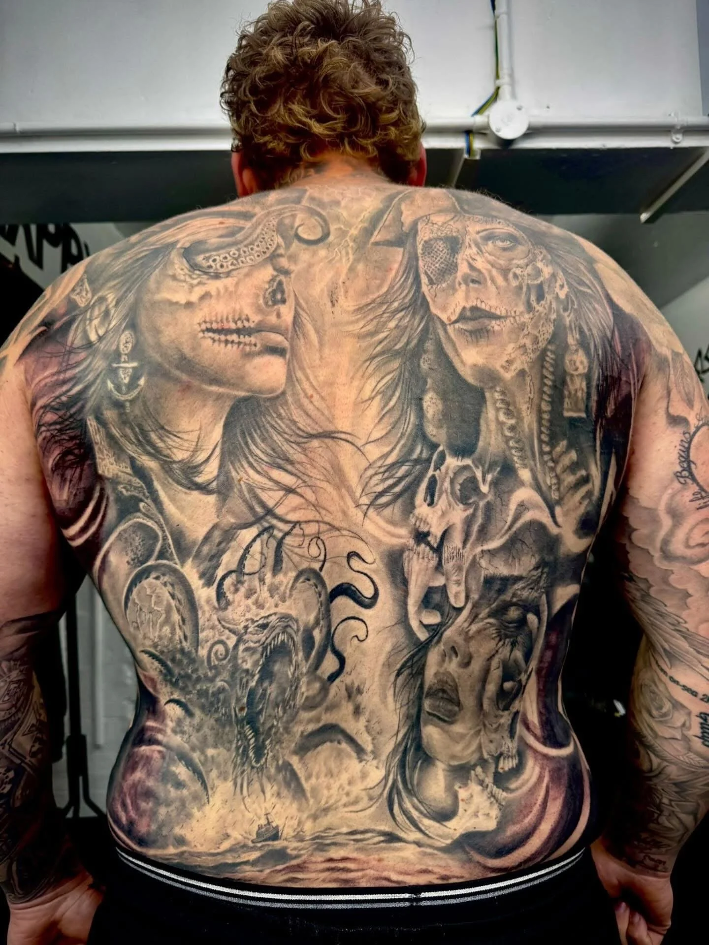 Huge under water / pirate themed back piece in black and grey realism