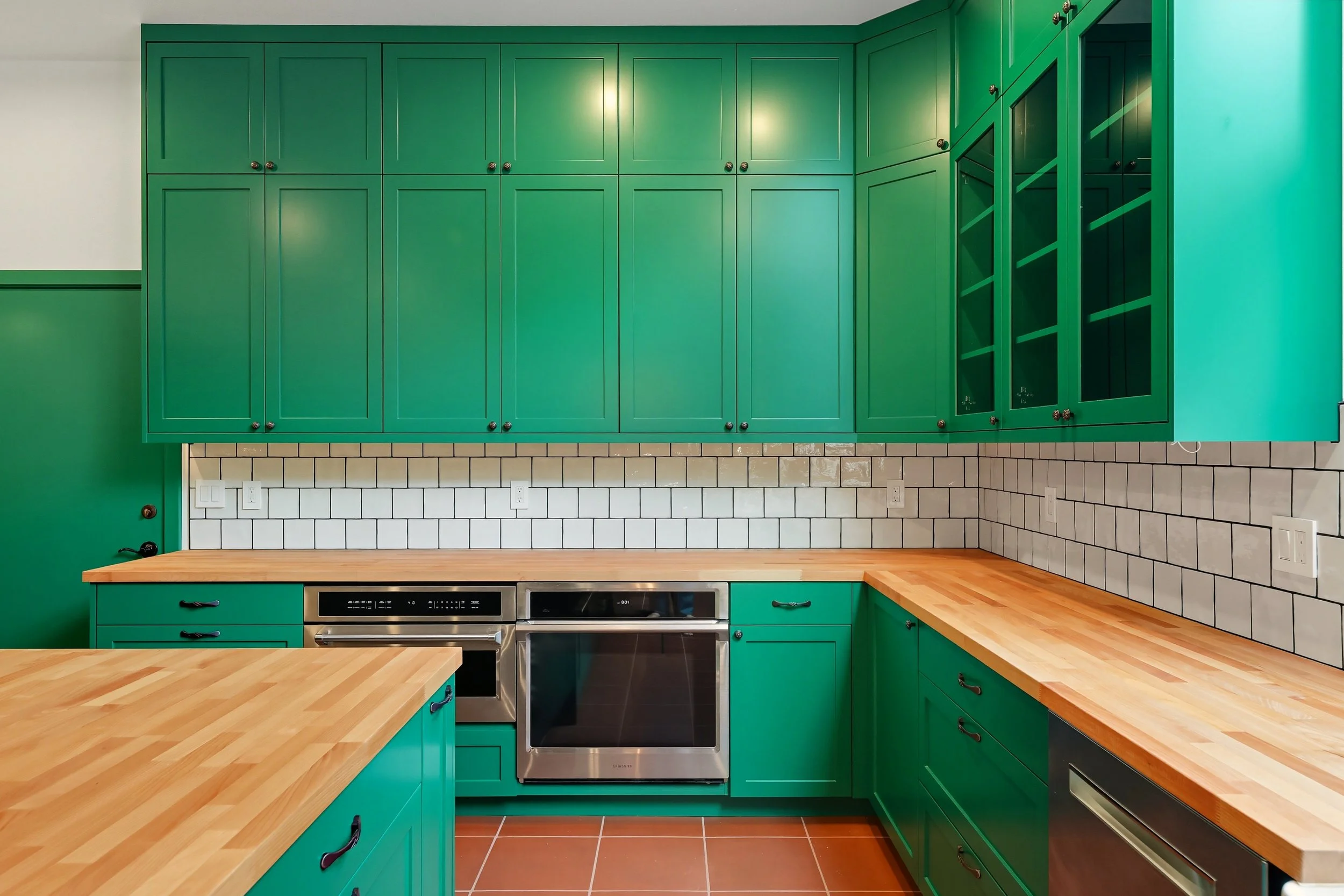 Green custom kitchen cabinets with butcher block countertops and white subway tile backsplash