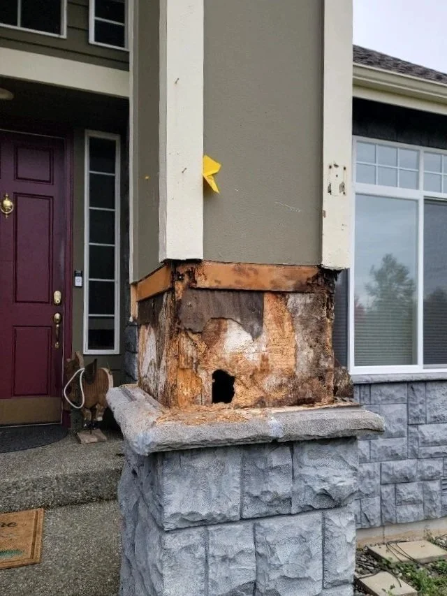 A vertical support column of a house located in Mill Creek, WA  showing the front porch pillar with severe structural dry rot damage. Nordic Home Solutions will provide residential dry rot repair, structural wood restoration, and siding replacement.
