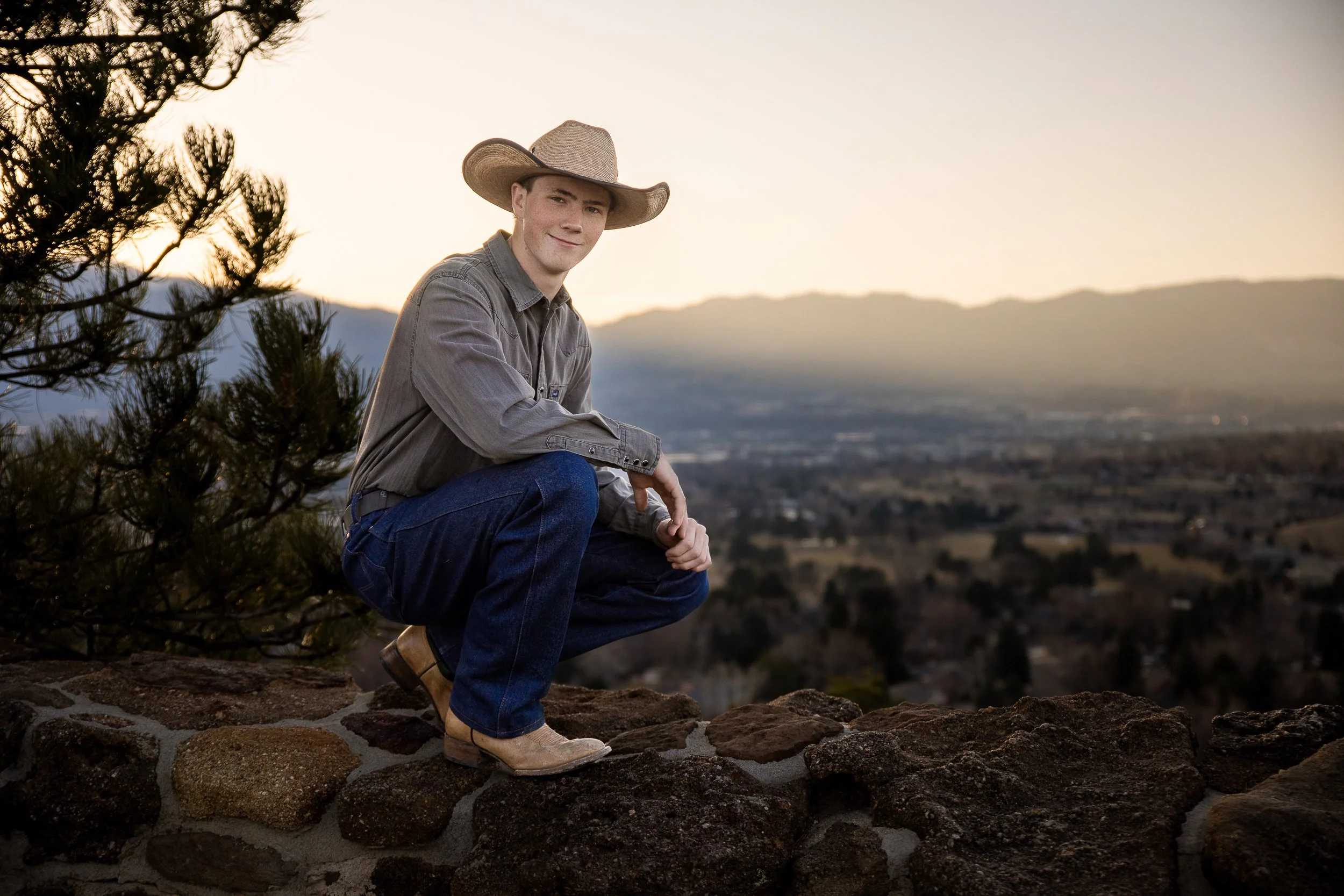 Claude responded: High school senior boy in cowboy hat sunset overlook Colorado Springs outdoor portrait sessionHigh school senior boy in cowboy hat sunset overlook Colorado Springs outdoor portrait session