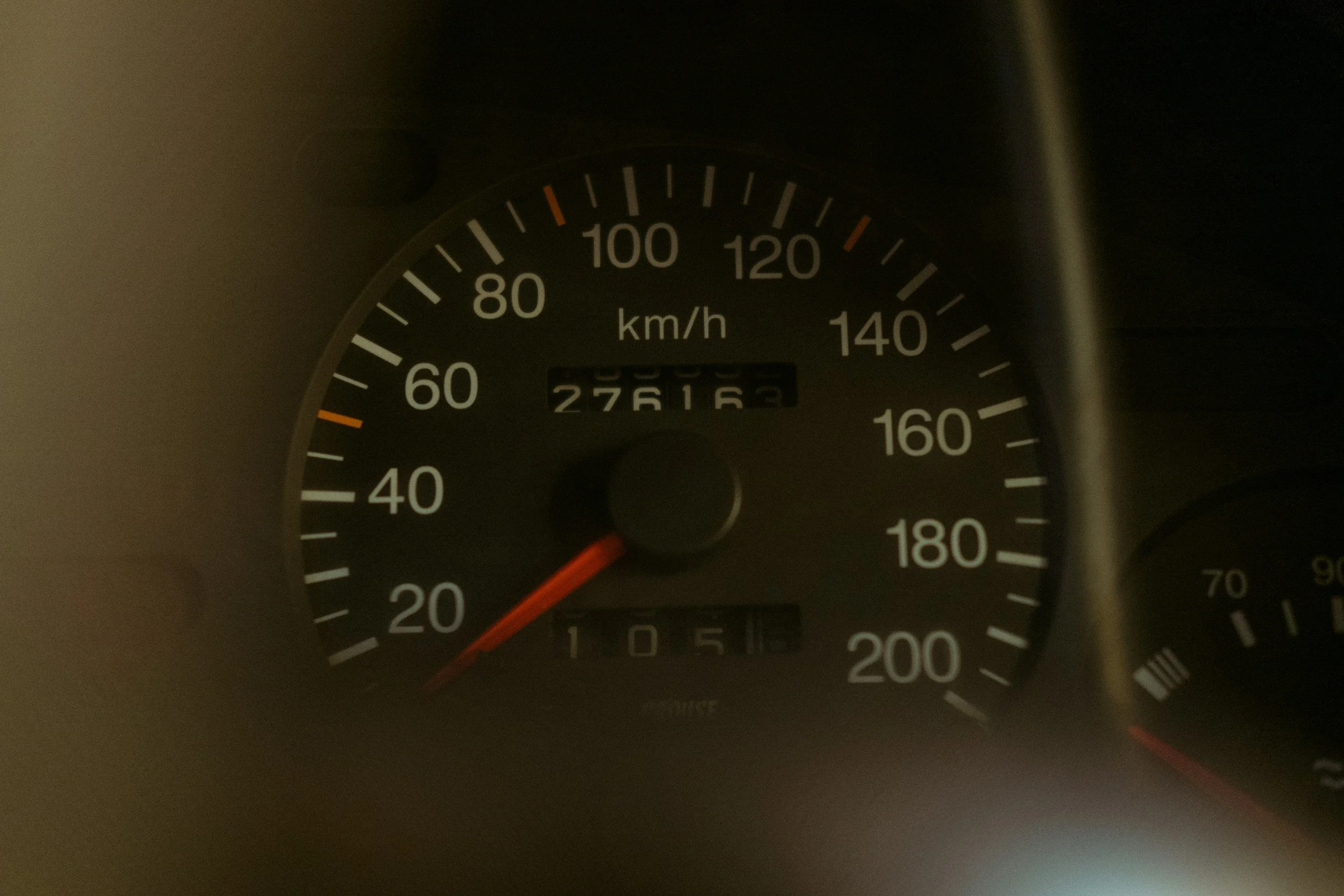 Car speedometer showing approximately 20 km/h, odometer reading 276165 kilometers, and clock showing 10:51.