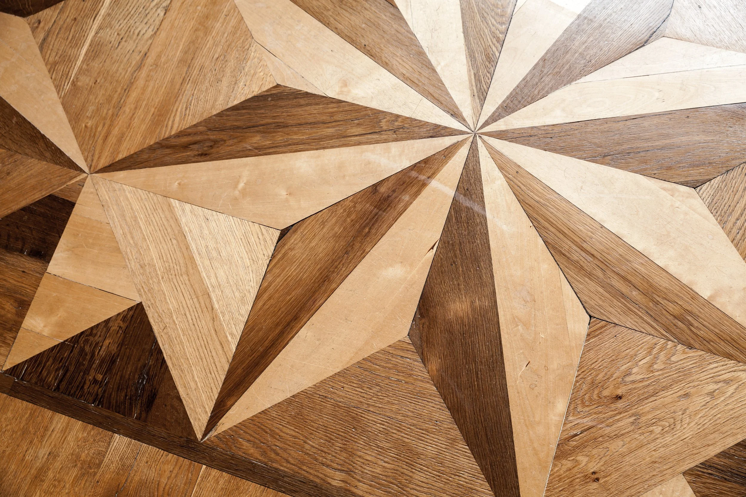 Craftsman installing wood flooring with precision and care