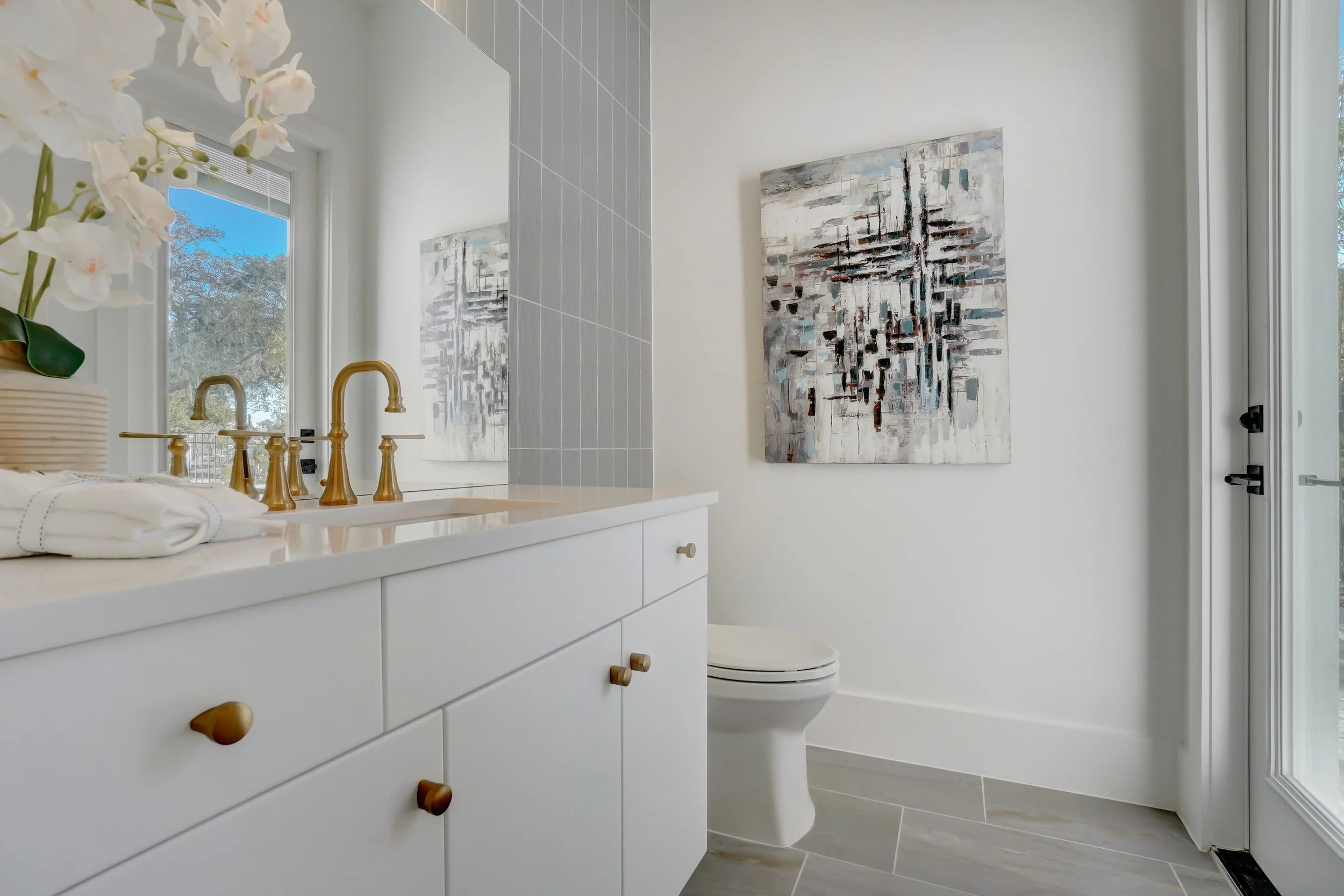Contemporary bathroom with light tile flooring and natural light