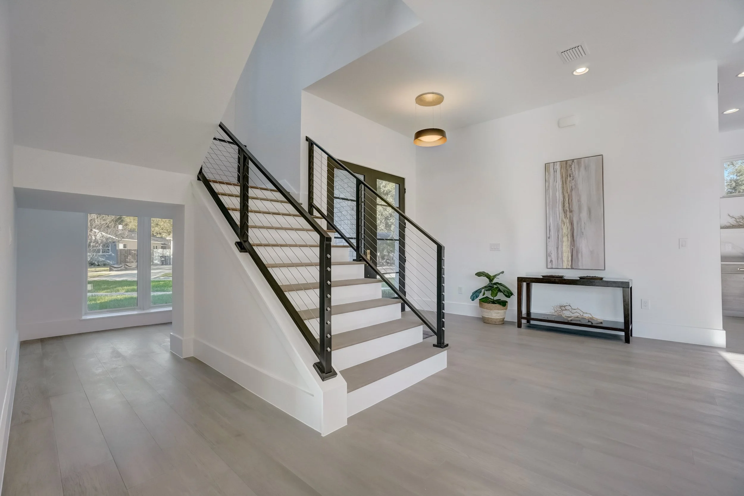 Open concept living space with hardwood flooring and natural light