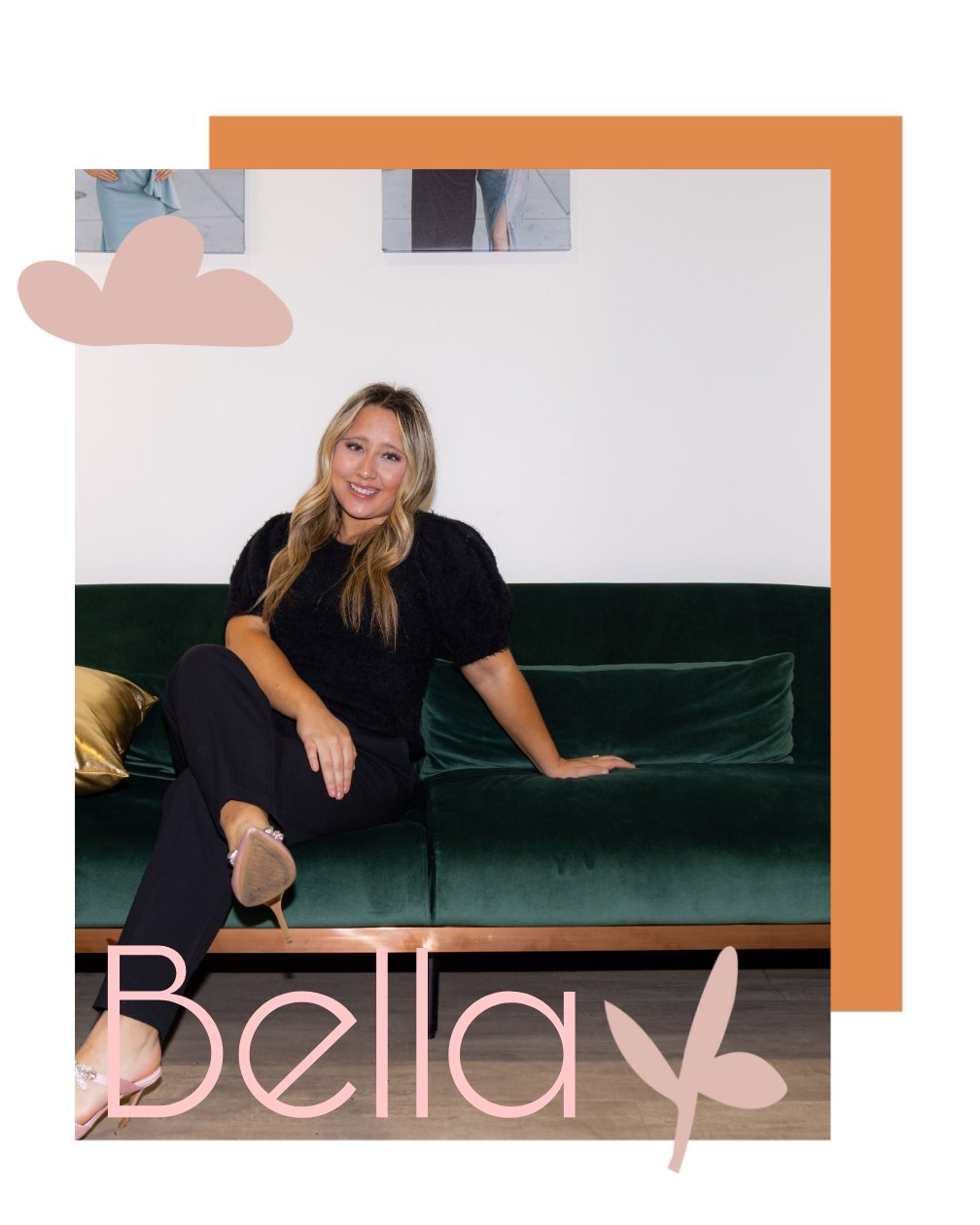 A woman with long blonde hair, wearing a black top and black pants, sitting on a green velvet sofa, smiling at the camera in a well-lit room with a white wall and framed pictures in the background, with decorative pink text saying 'Bella' and a pink leaf graphic.
