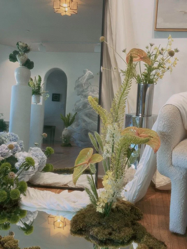 Studio Greenhouse @casaromanticasc 

Picture stepping into a hidden clearing where the air feels soft as if the garden is quietly watching you. The installation unfurls like a living story, winding paths of moss curl between clusters of luminous bloo