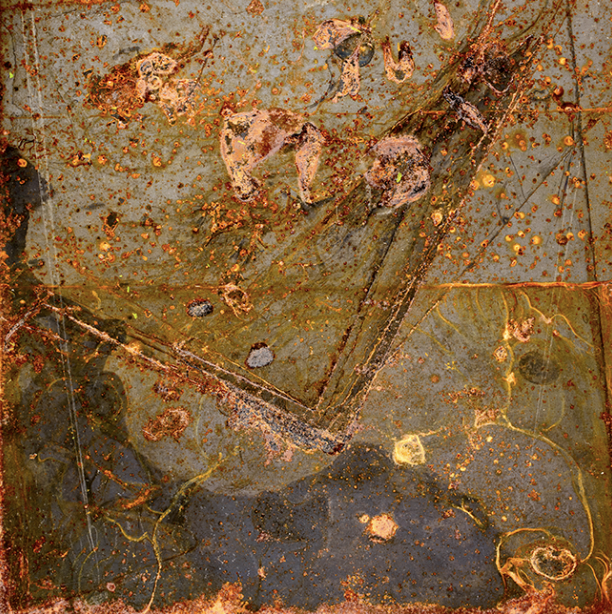 Close-up of a rusty, old metallic surface with peeling paint, dirt, and corrosion, showing various textures and colors like orange, brown, and gray.