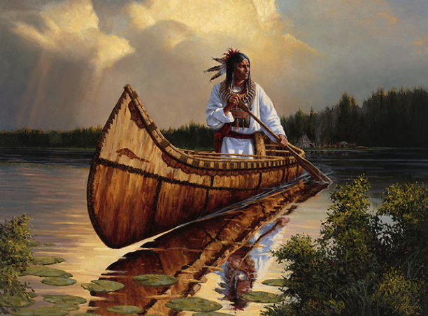 A Native American man dressed in traditional clothing stands on a canoe in a lake, holding a paddle, with trees and a cloudy sky in the background.