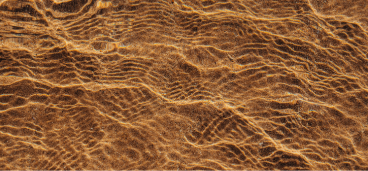 Close-up of rippled sand in clear water