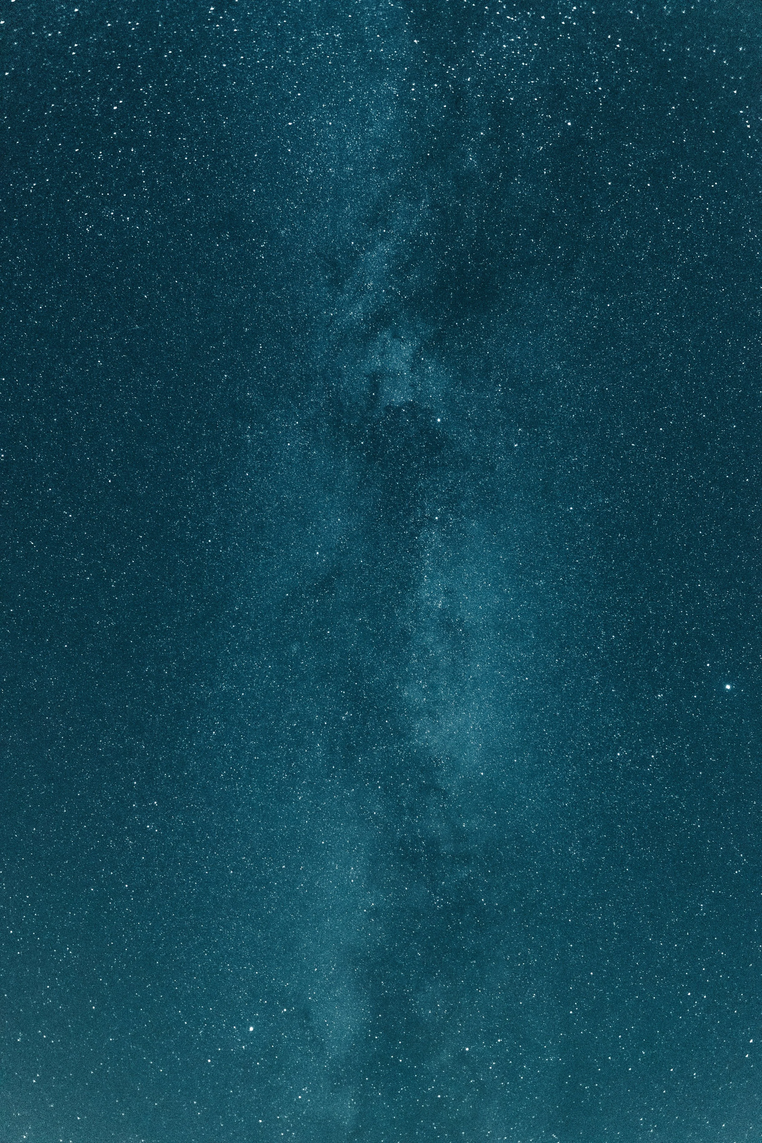 A clear night sky filled with countless stars and a visible section of the Milky Way galaxy.