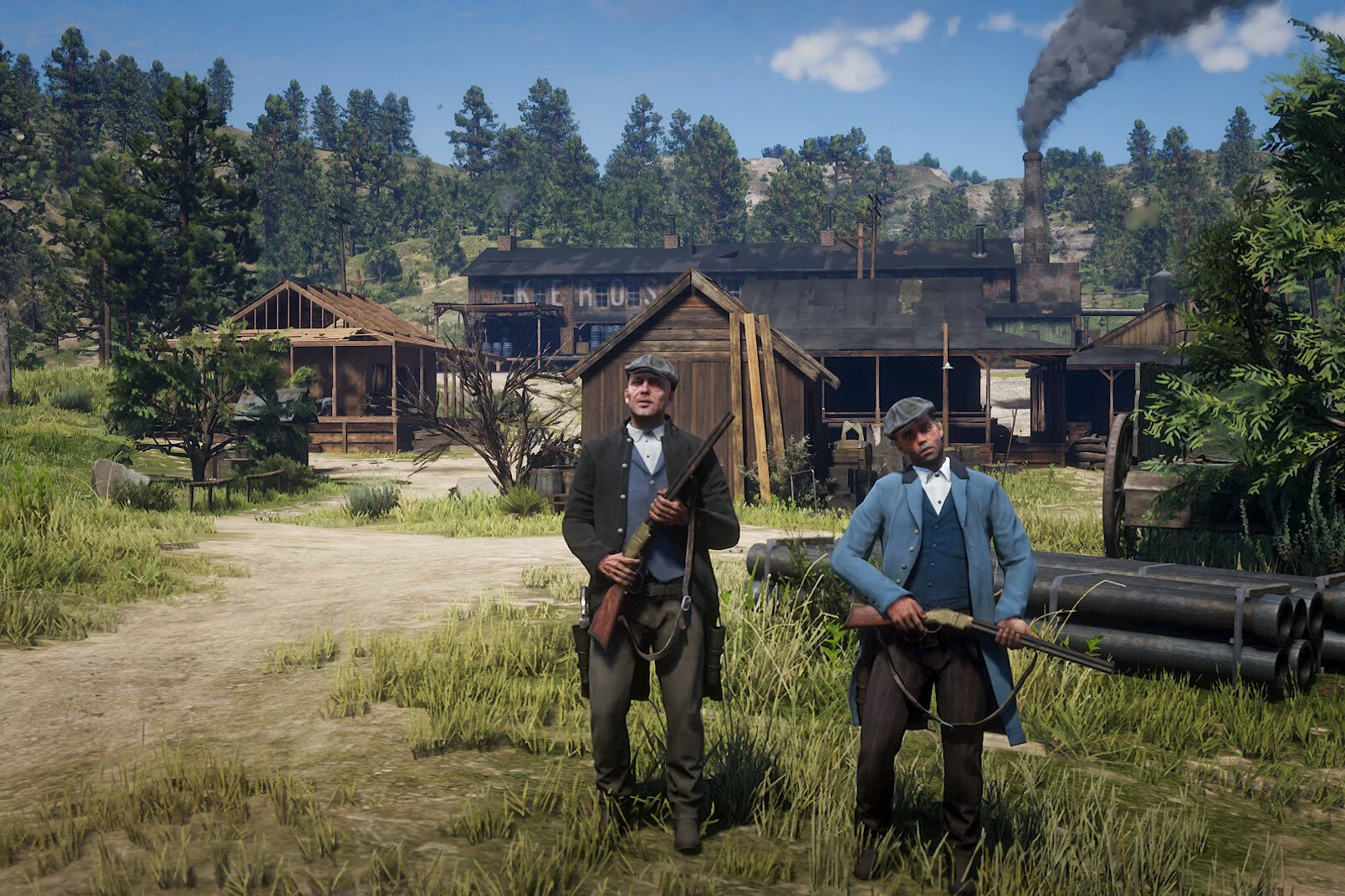 Two men dressed as soldiers from the Civil War era standing outside a wooden building with a smokestack emitting smoke, surrounded by grassy fields and trees.