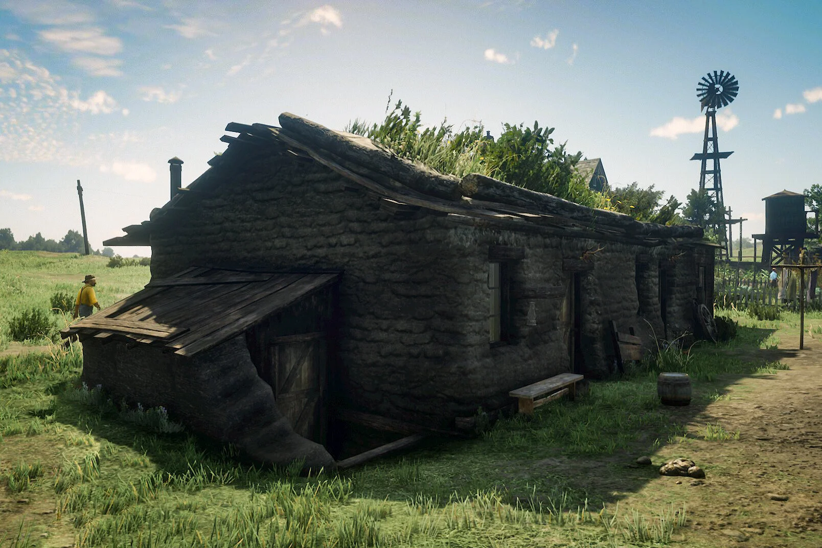 An old, rustic wooden house with a slanted roof covered in grass and plants, set in a rural landscape with a windmill in the background.