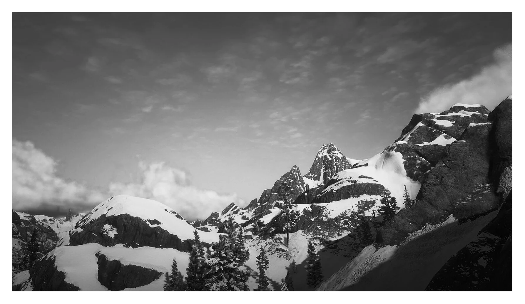 Snow-covered mountain peaks under a cloudy sky with trees in the foreground and dark rocks on the right side.