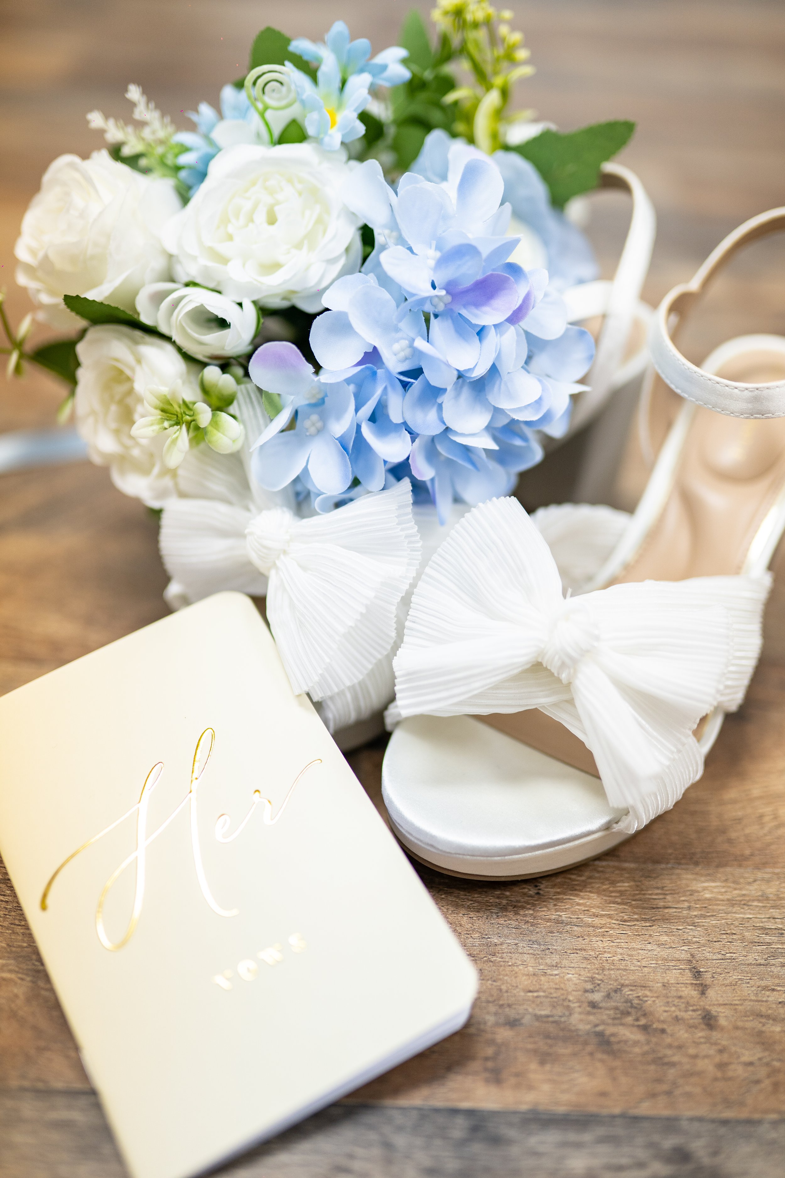 Photo of shoes and flower and wedding vow book