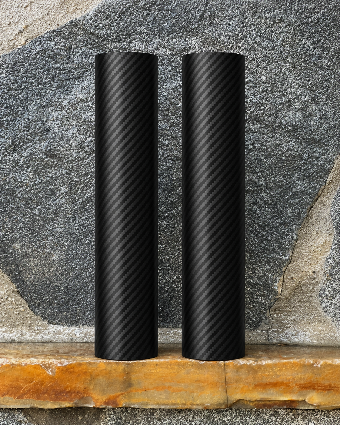 	
Two black RokPro E-Moto motorcycle fork guards standing upright against a textured stone wall background.
