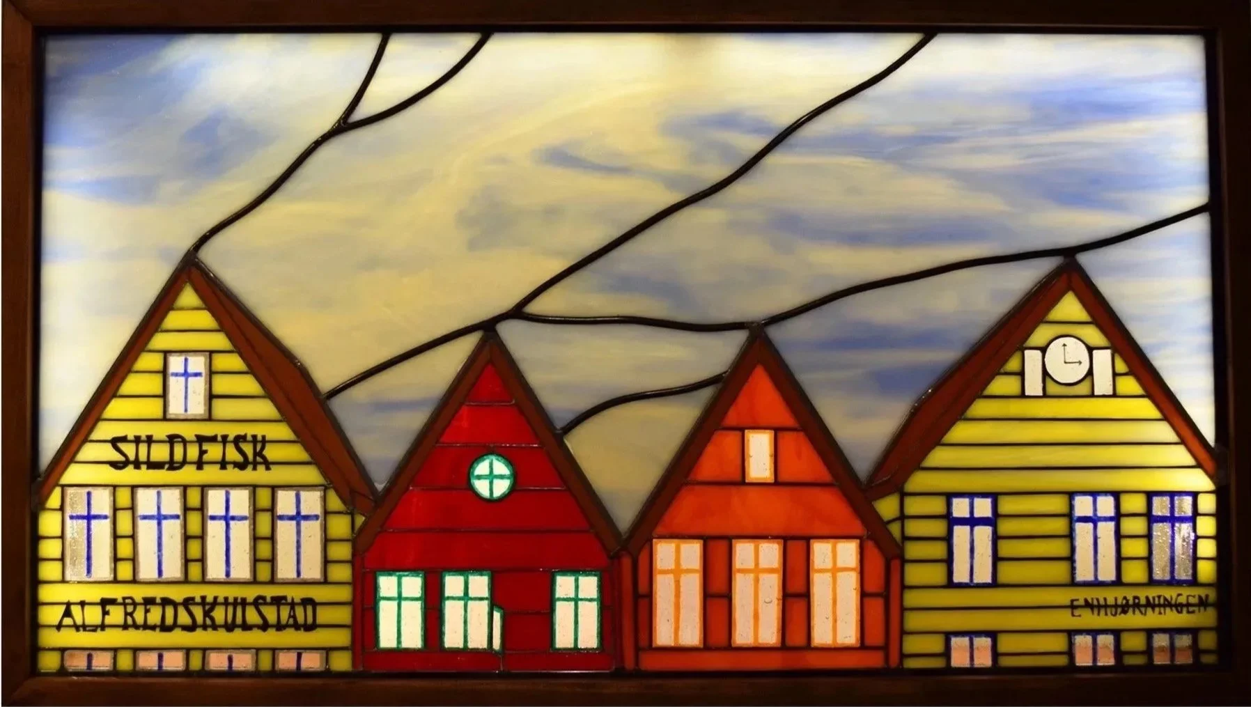 custom stained glass window of four Norwegian building in yellow red orange