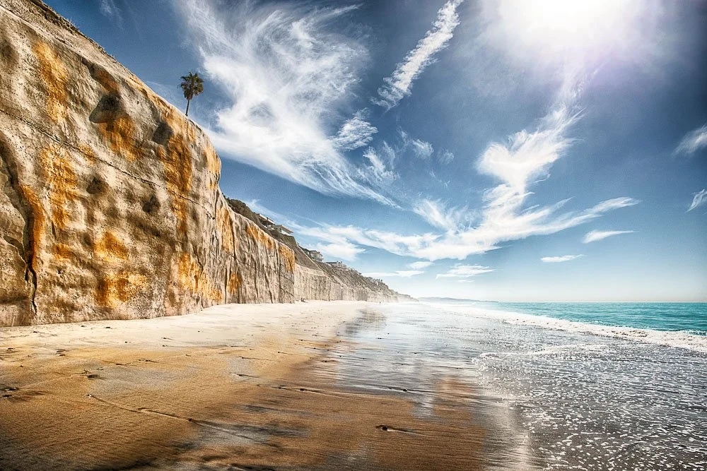 seawalls and wispy clouds at tide park beach in solana beach california.jpg