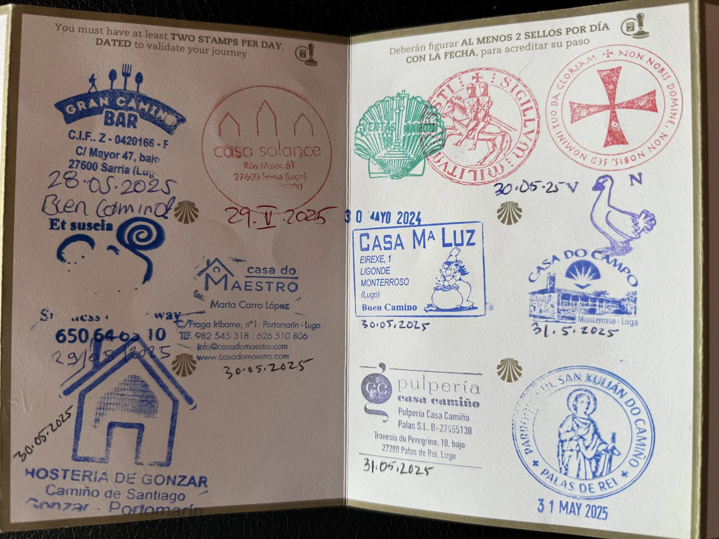 Collection of various colored stamps, including red, blue, green, and purple, each with different designs and texts, marked with dates and locations, on a page.