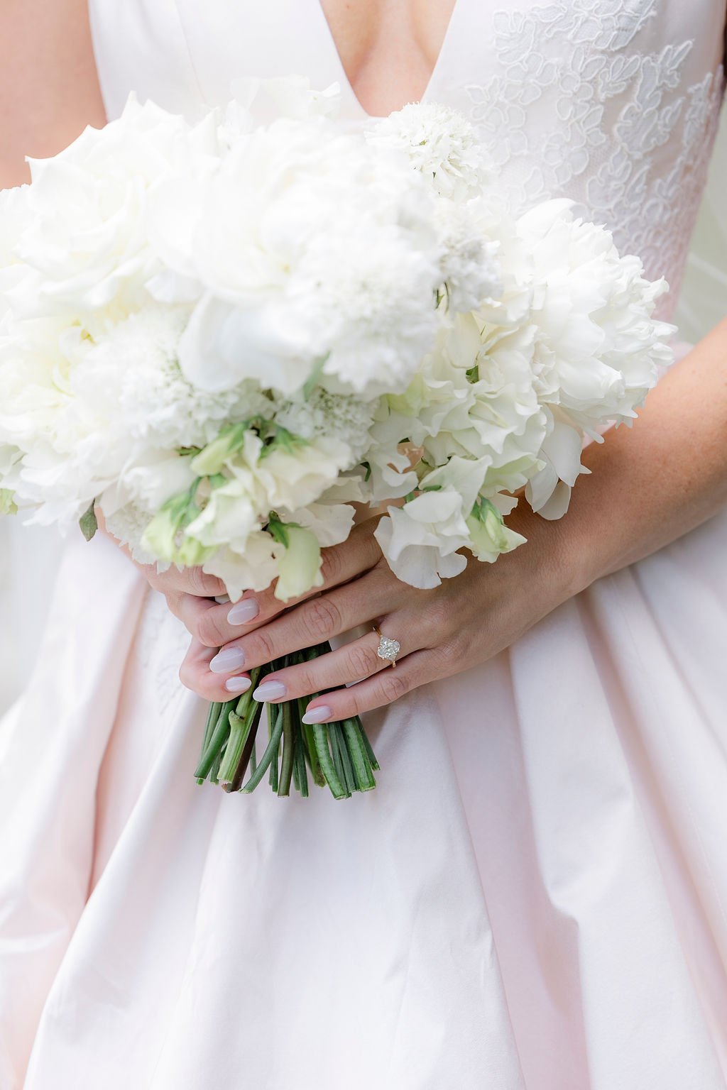 Bride holding white bouquet in a wildflower field during her Grand Teton wedding