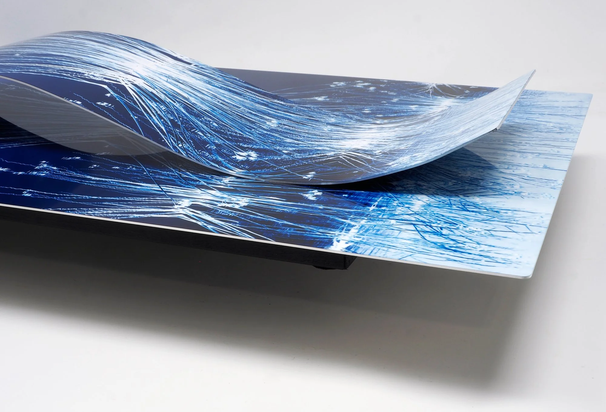 corner view of color-altered image of dried grasses in a pond