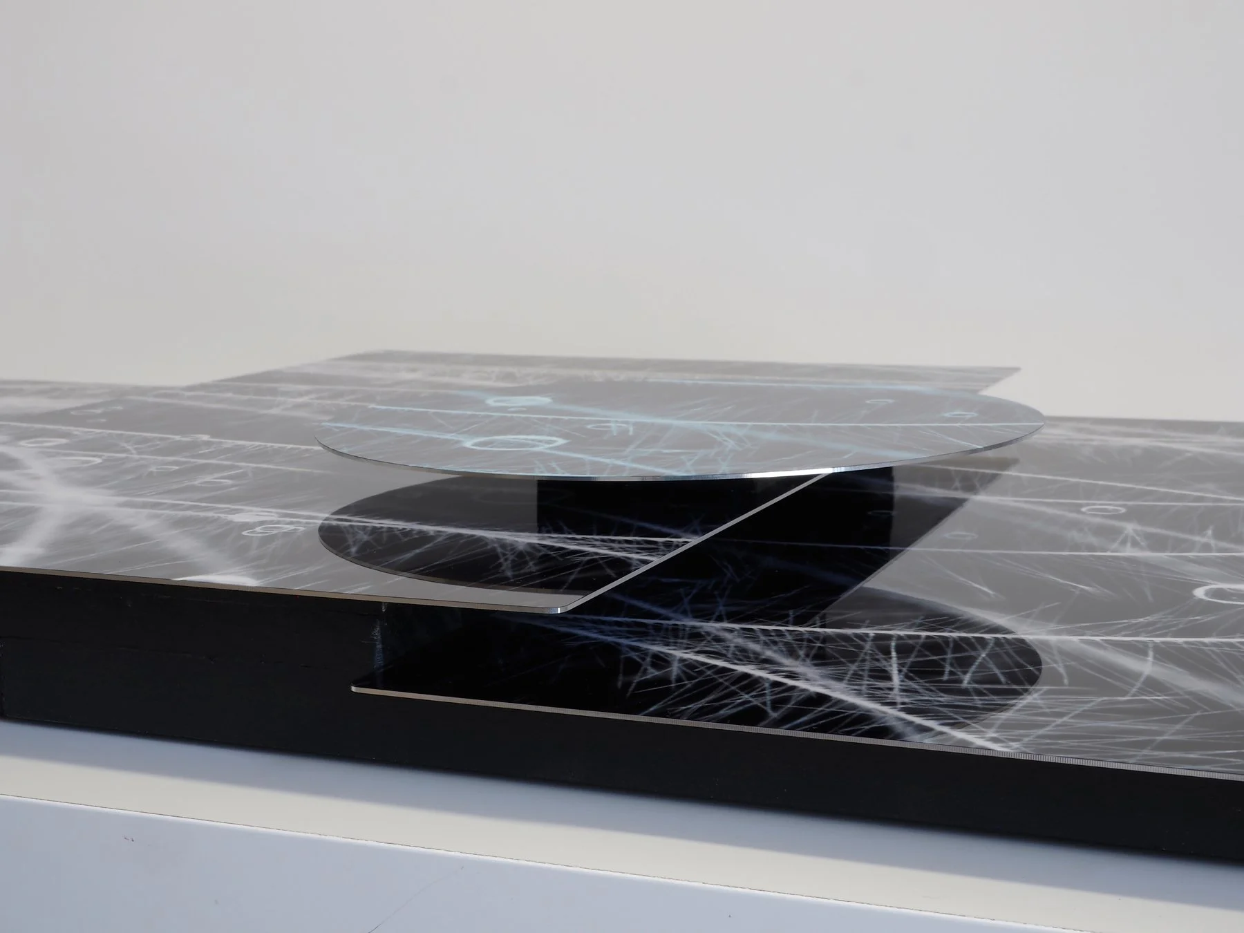 side view of large sculptural image of goose feather with water drops