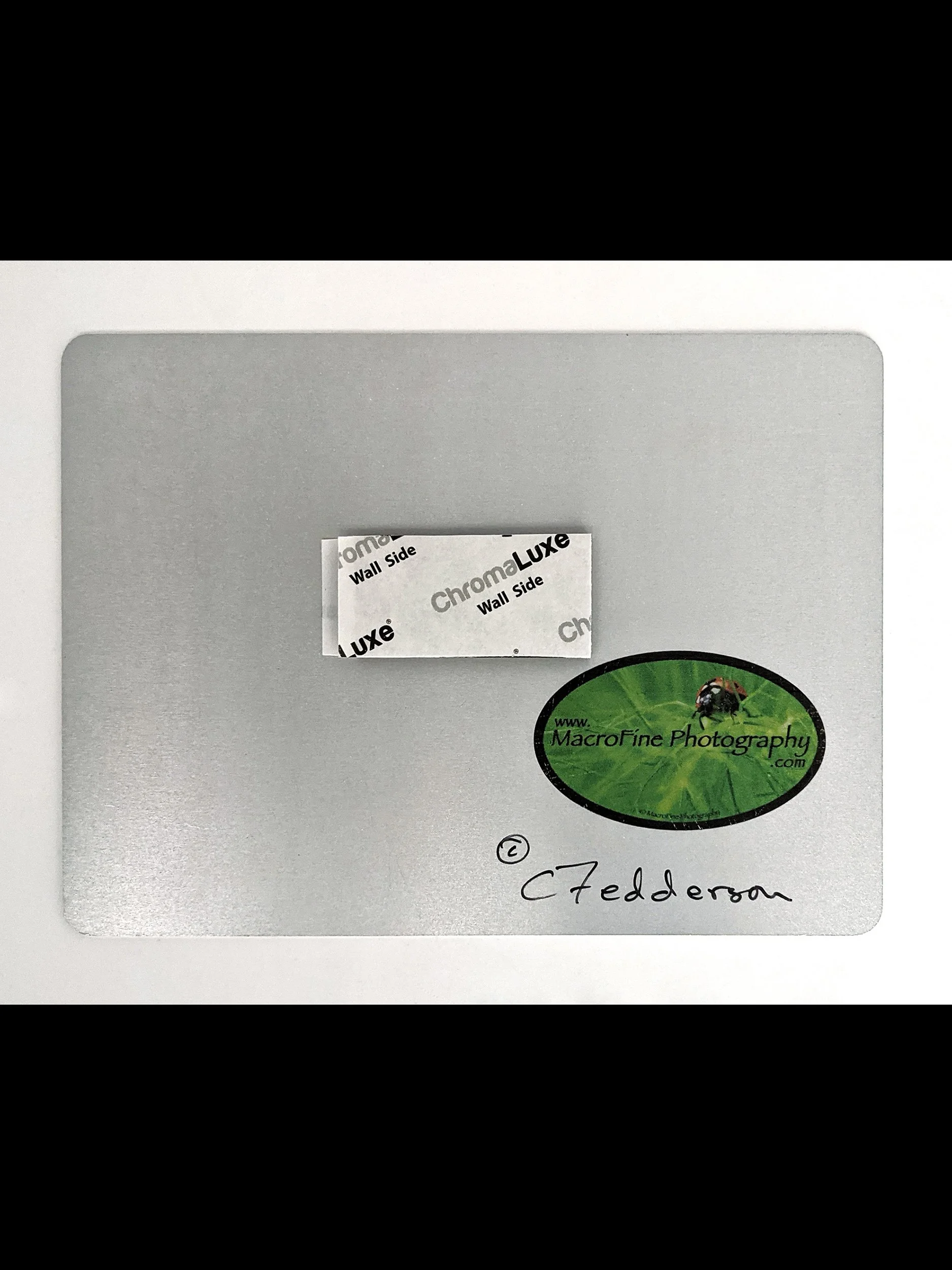 back of aluminum showing sticky pad hanger