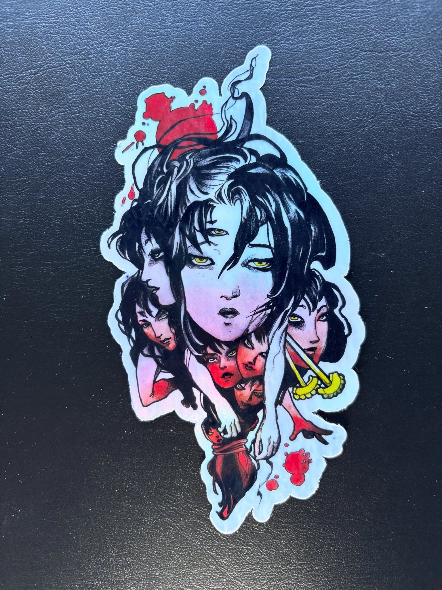 A sticker illustration featuring multiple stylized women with dark hair, some with red accents and jewelry, arranged in a collage-like manner on a black background.