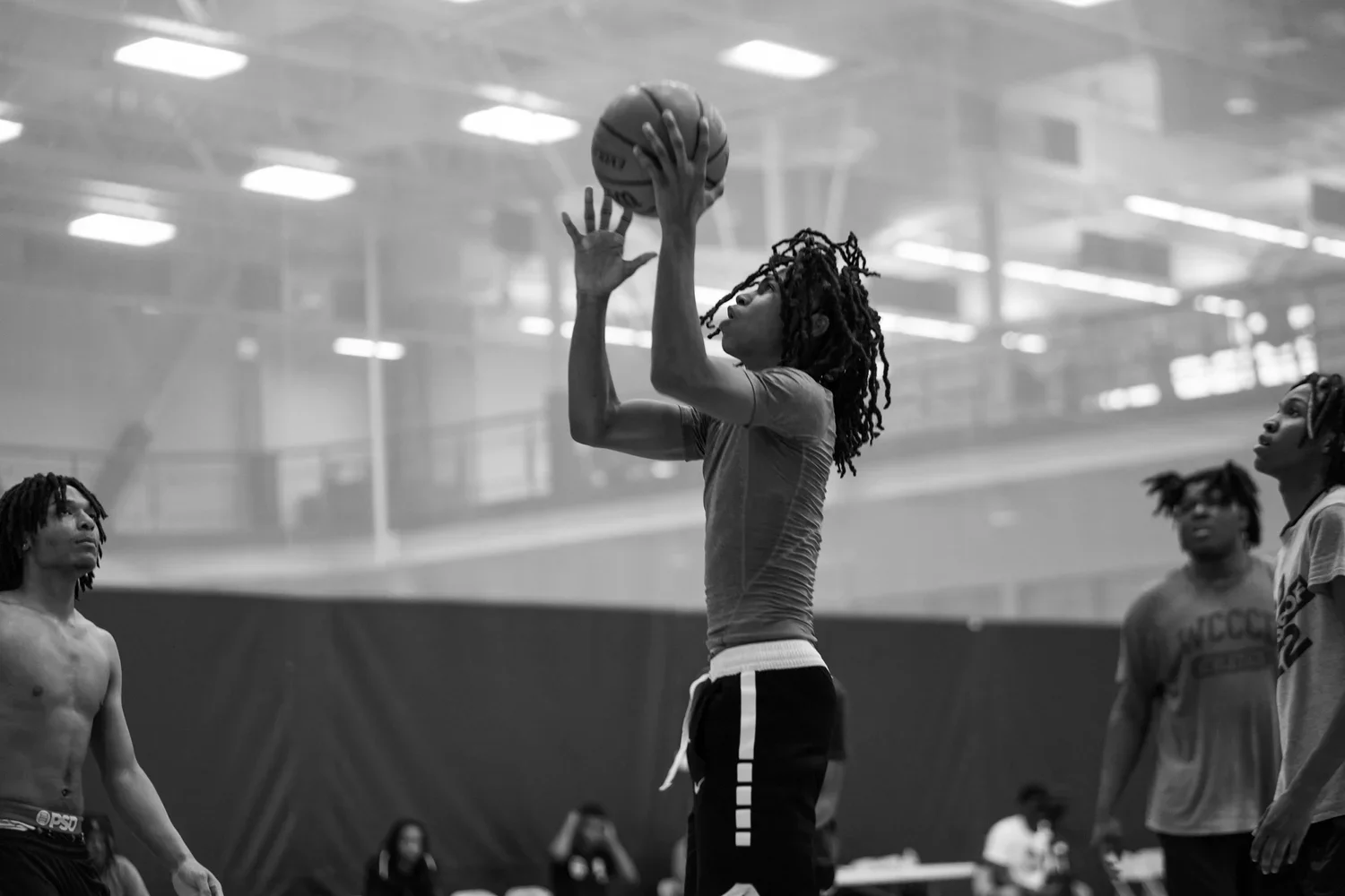 Basketball playing shooting a floater during a tournament sponsored by The Austin Foundation.