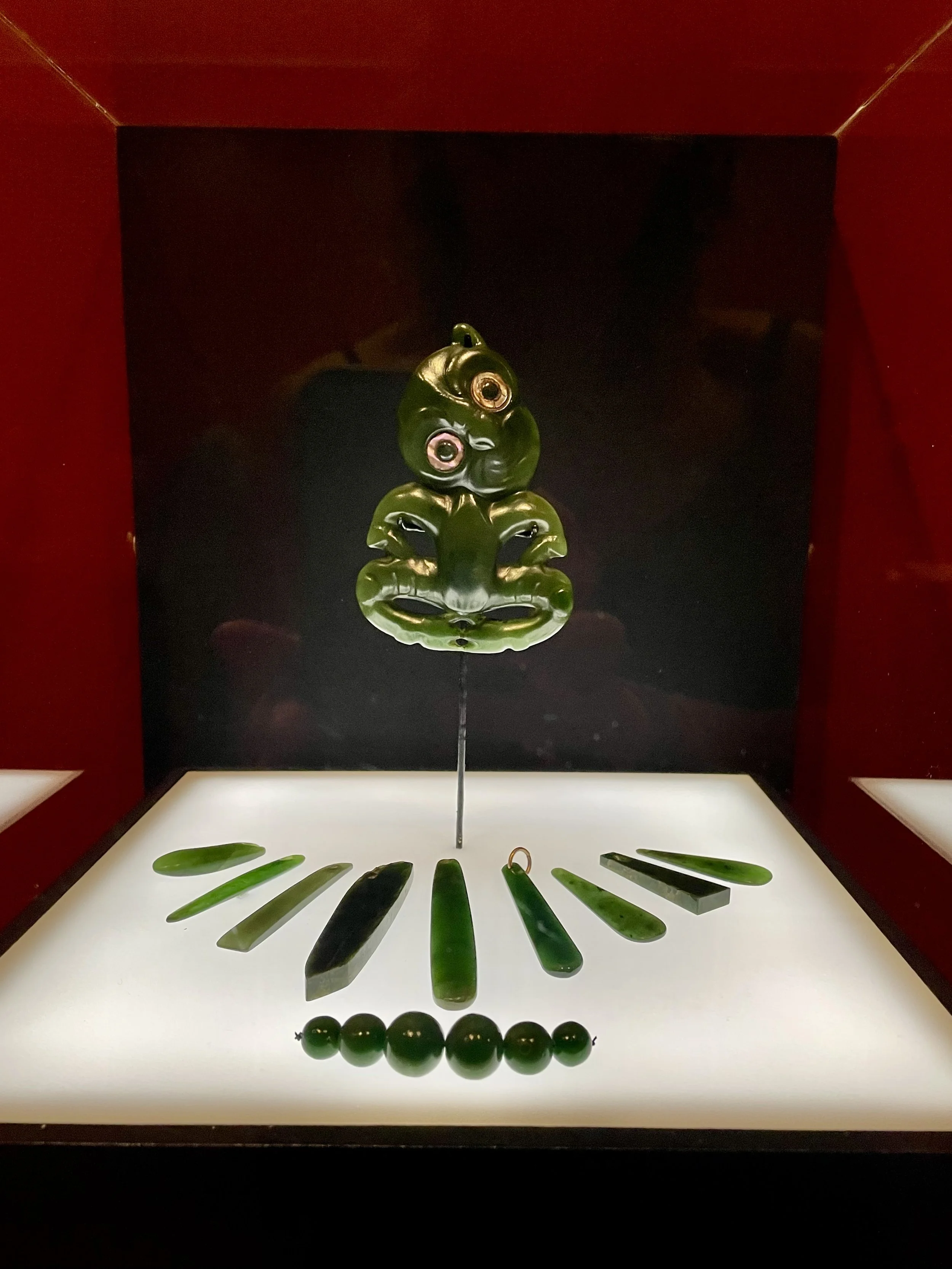  Picture taken by the author of Hei Tiki carved in  pounamu  (greenstone), from the exhibition  He Kapuka Oneone  – A Handful of Soil at Christchurch Art Gallery.    ‘In Māori legend, some say Tiki was the first man, created by Tāne, the  atua  (God)