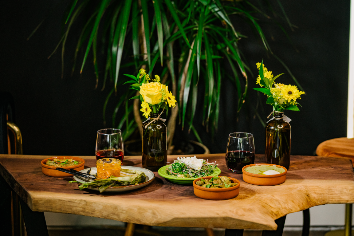 Table Spanish Tapas Greens Romesco Calcot Wine.png