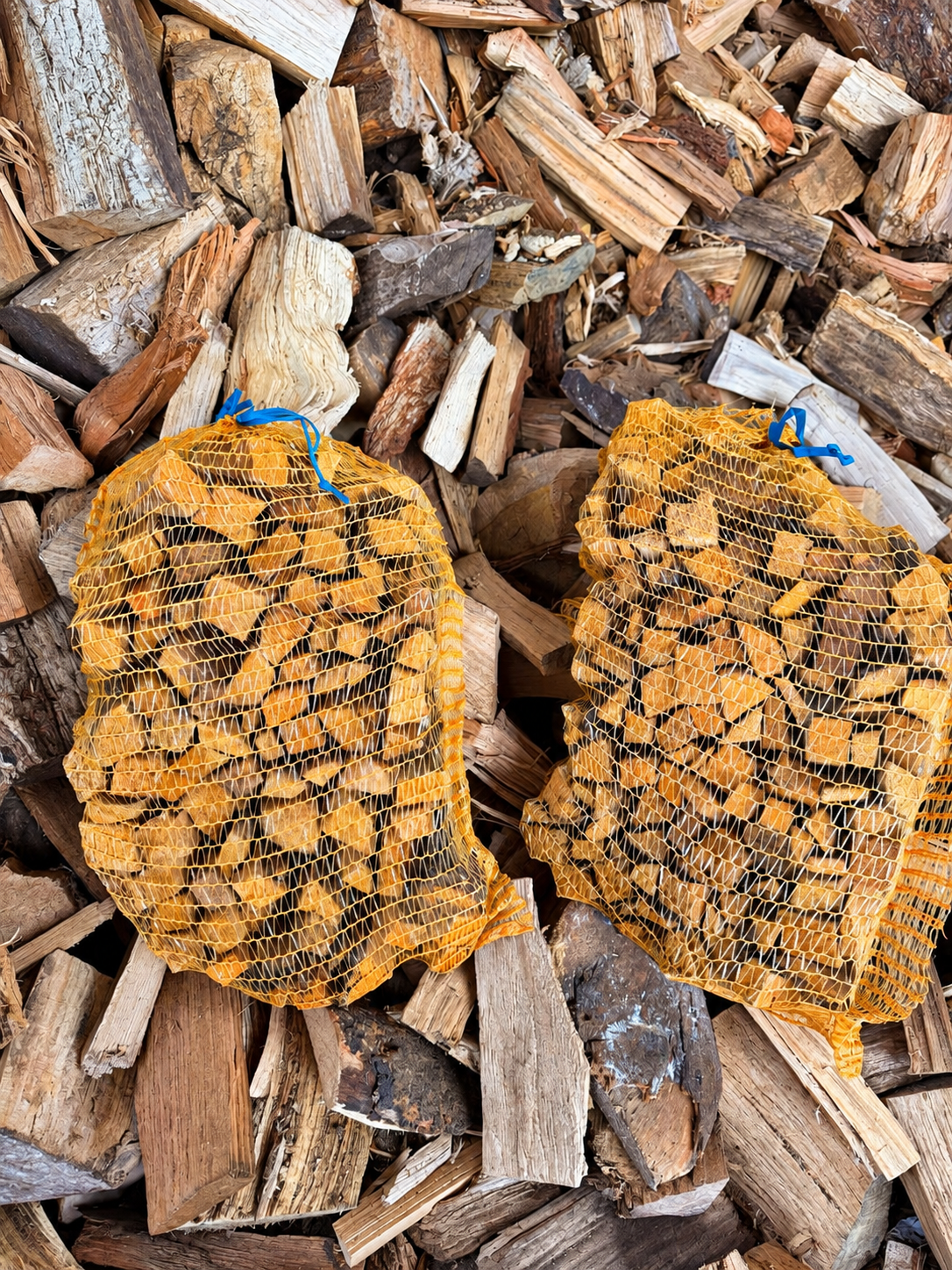 Sacks of Kindling on Firewood Pile