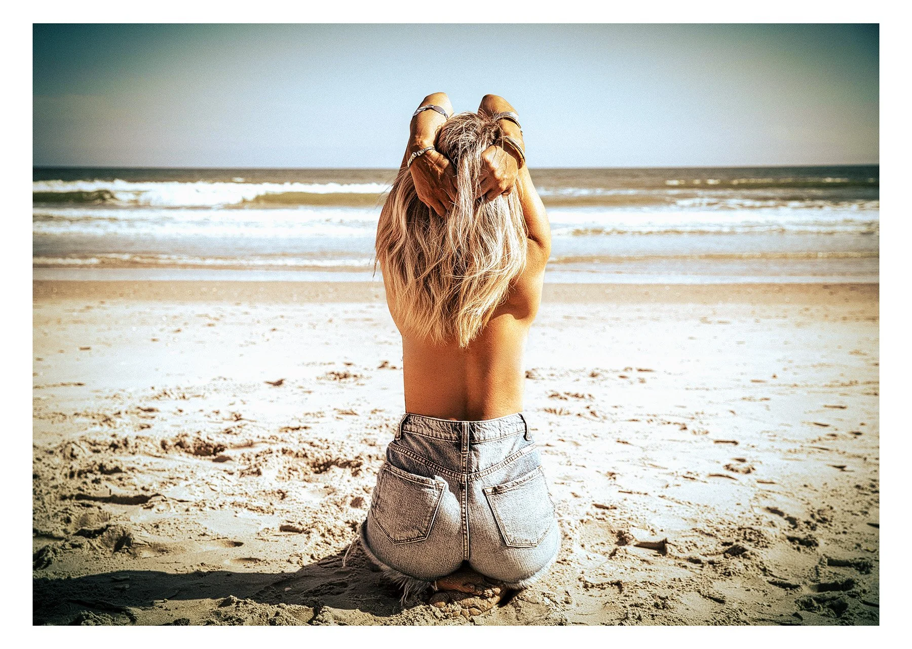 woman on the beach in cutoff shorts freedom