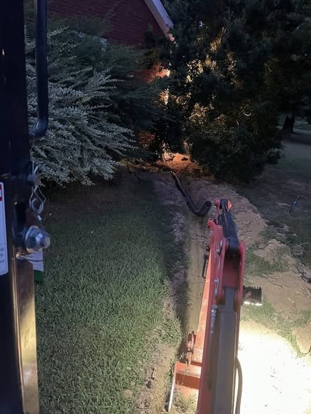 Trenching and underground drain pipe installation for residential drainage system