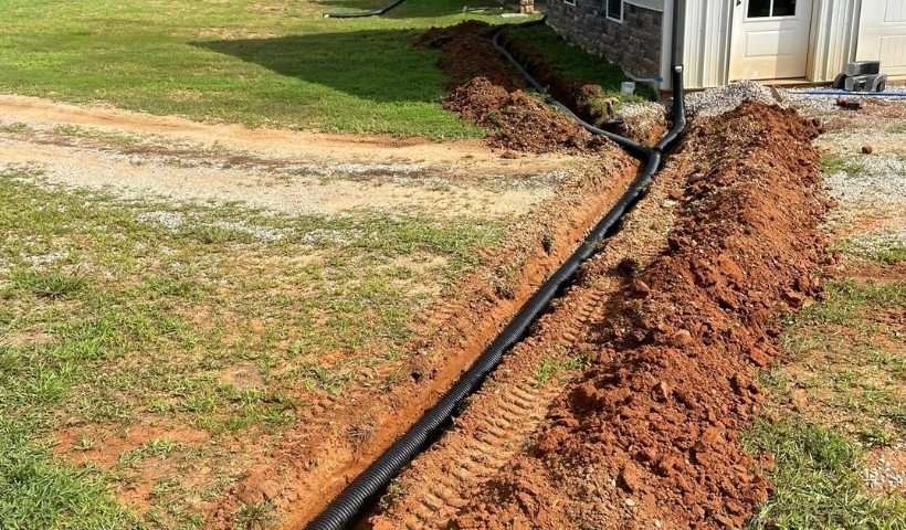 Underground gutter drain pipe installed in trench for stormwater runoff control