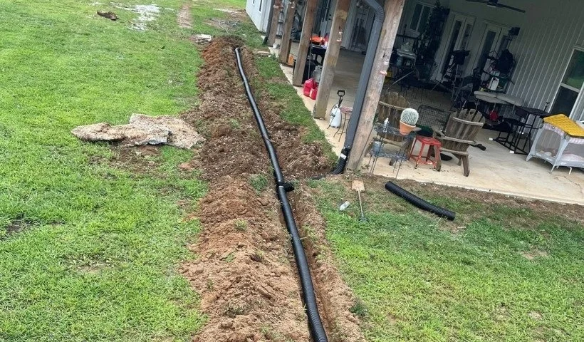 Residential stormwater drainage line installed to reduce erosion and standing water