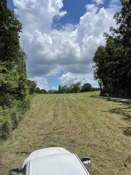 Field after brush hogging showing cleared land in Estill Springs, TN