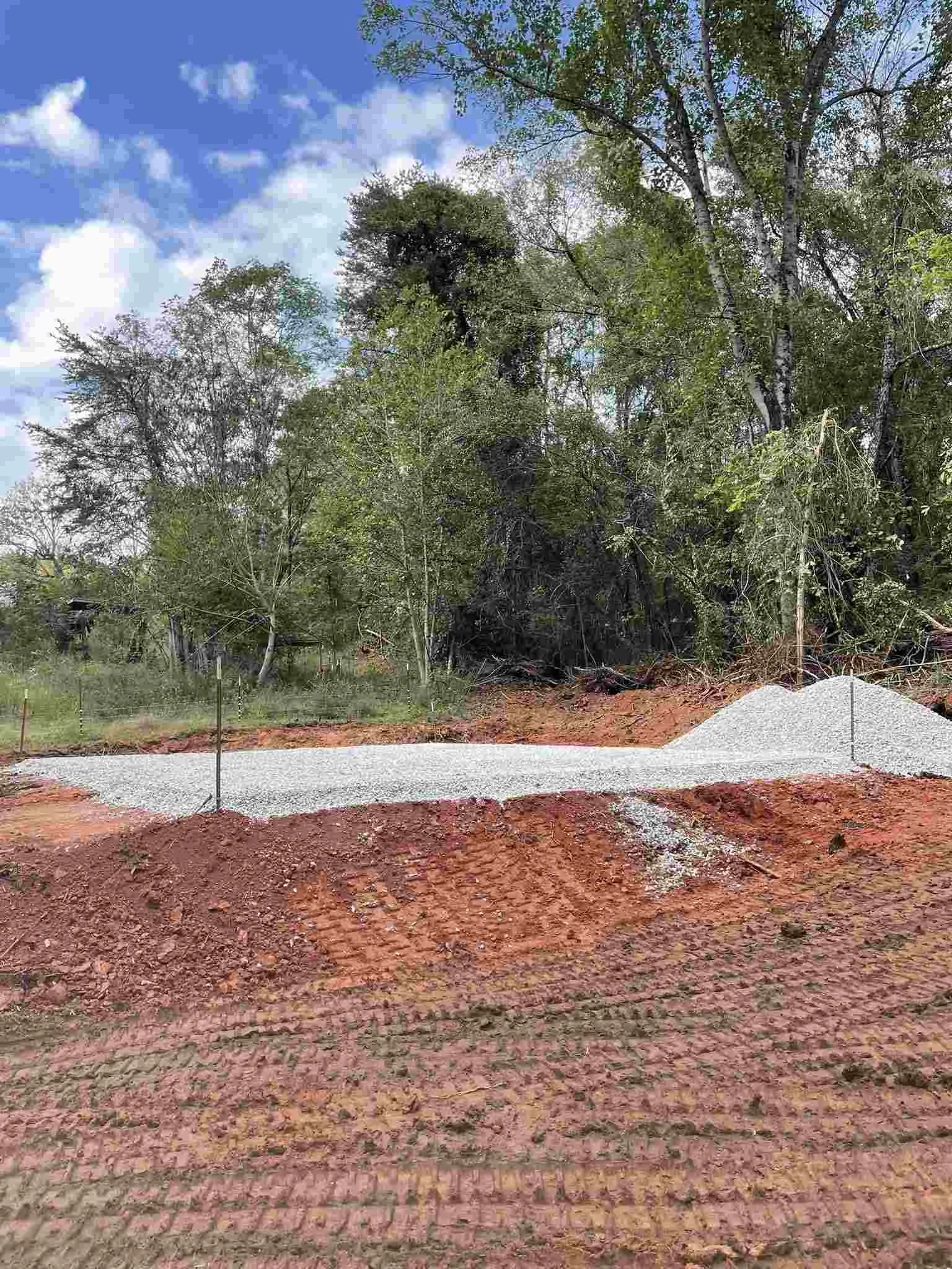 Adding 3/4 gravel base to excavation pad during site preparation in McMinnville, TN