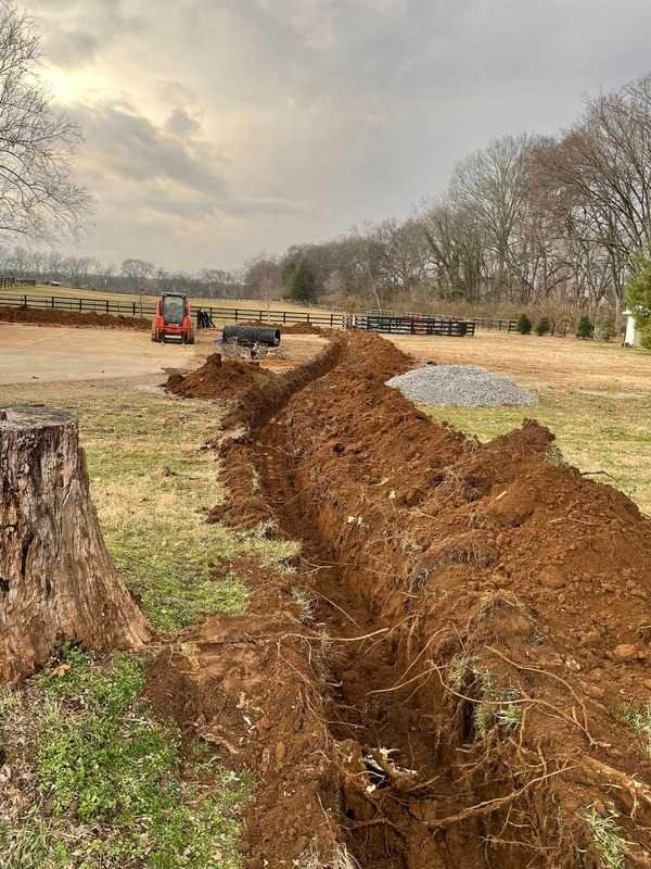 Trenching work for site preparation and underground utility installation in Middle Tennessee.