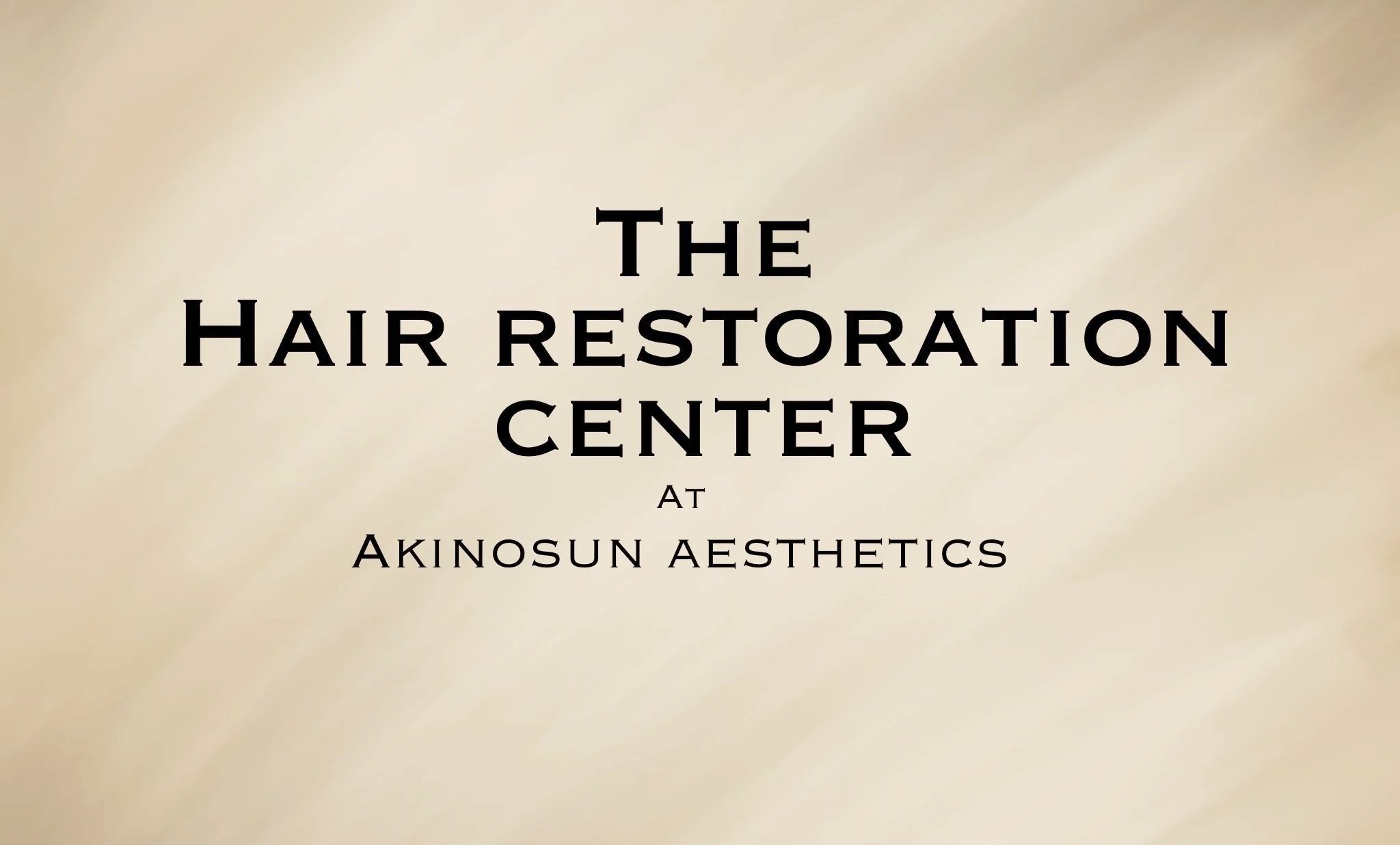 Text on a beige background reading "The Hair Restoration Center at Akinosun Aesthetics".