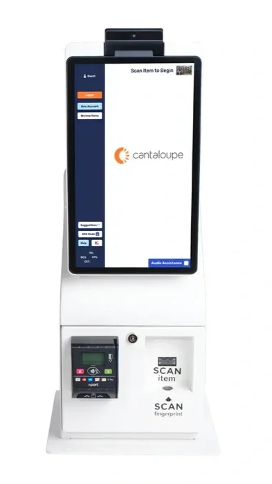 A white self-service kiosk with a large touchscreen displaying the Cantaloupe logo, a card reader, and a scanner for items and fingerprints.
