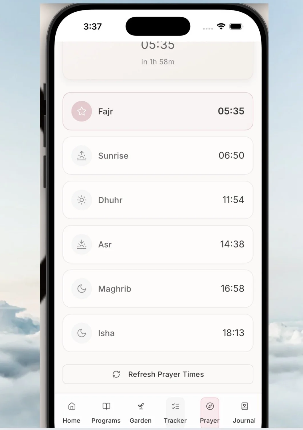 Smartphone screen displaying Islamic prayer times for Fajr, Sunrise, Dhuhr, Asr, Maghrib, and Isha with icons, and navigation menu at the bottom for Home, Programs, Garden, Tracker, Prayer, and Journal.
