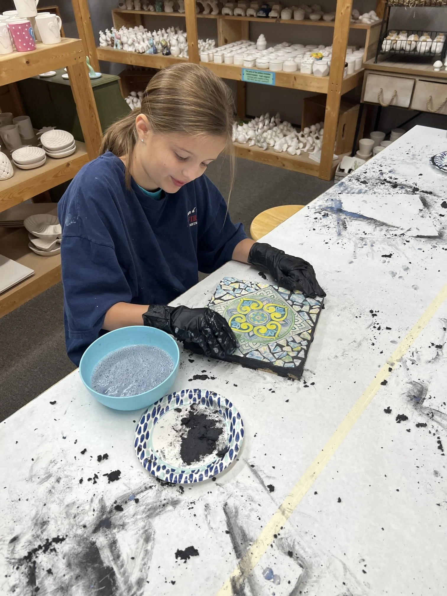 A child creates a tile mosaic