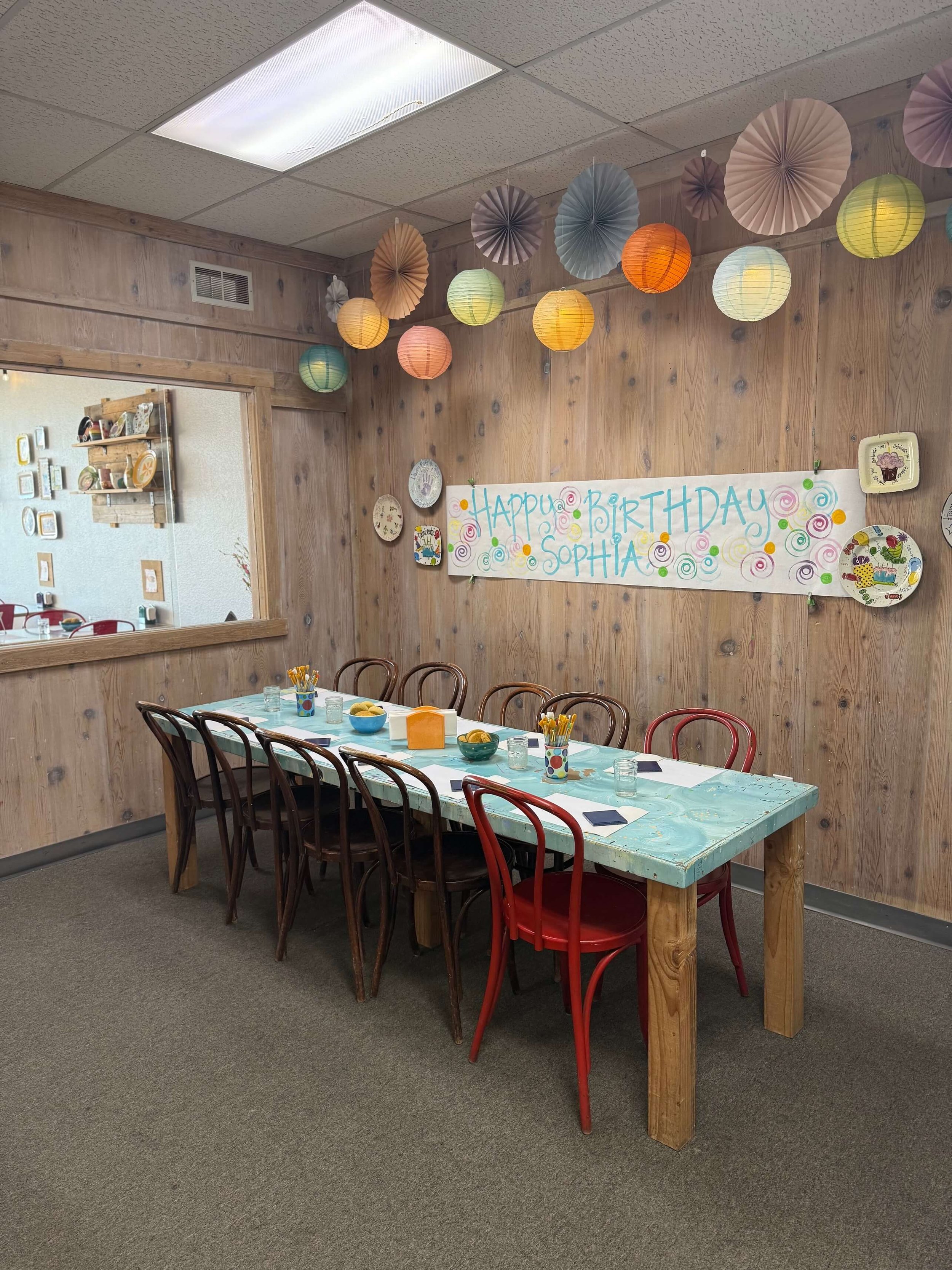 A table in the party room under a Happy Birthday Sophia banner