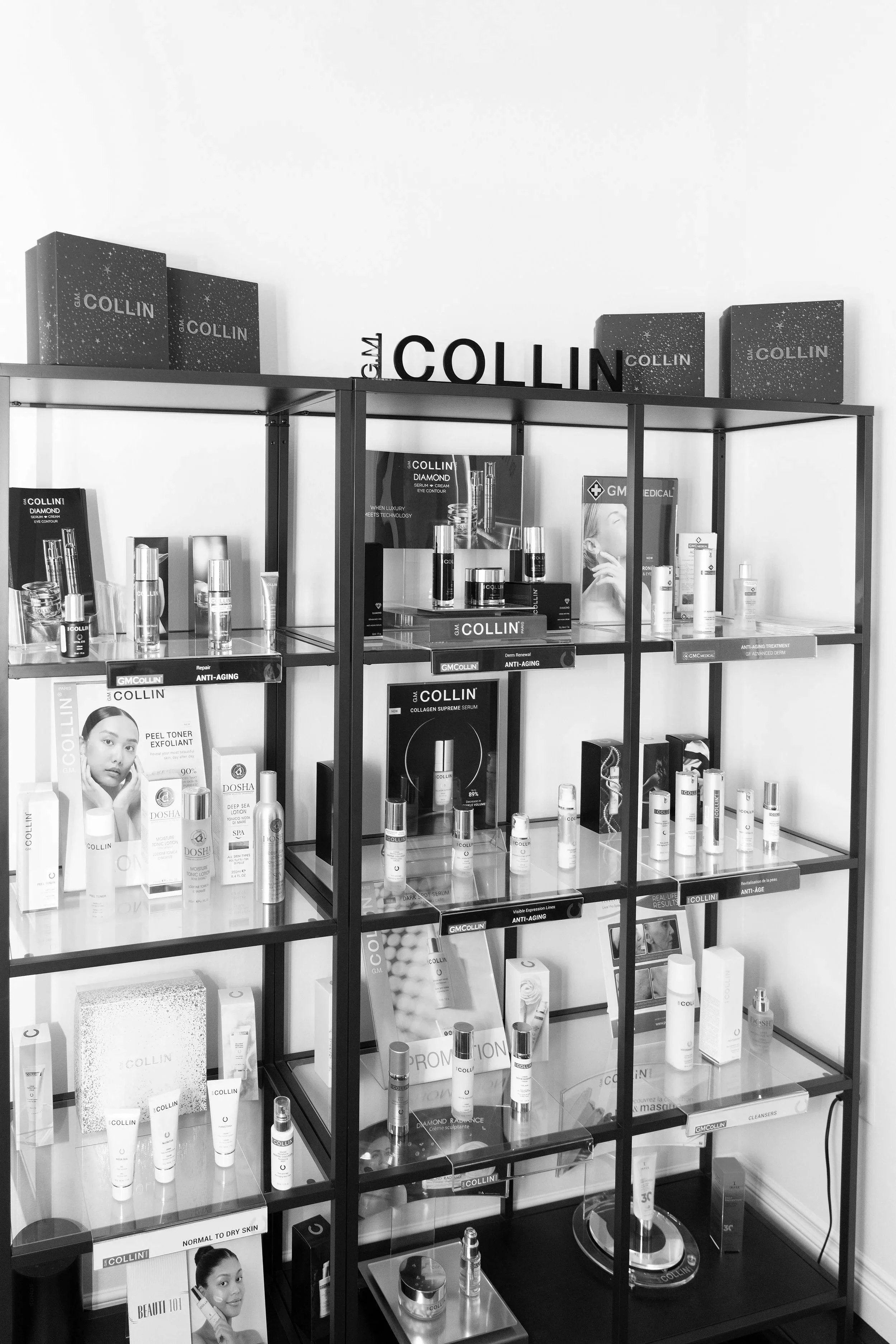 Display shelf with skincare products and promotional materials, branded with Collin, arranged in a grid pattern.