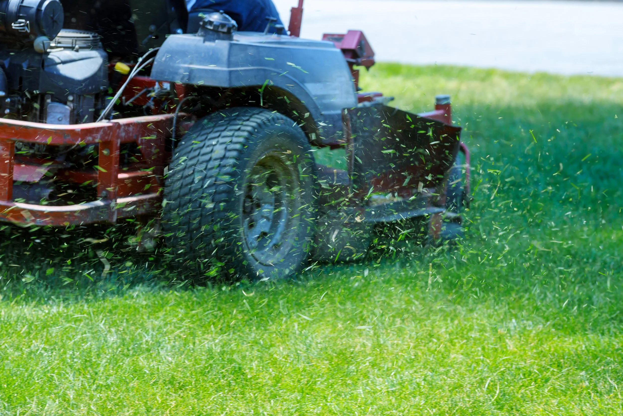 A lawn mower cutting grass.