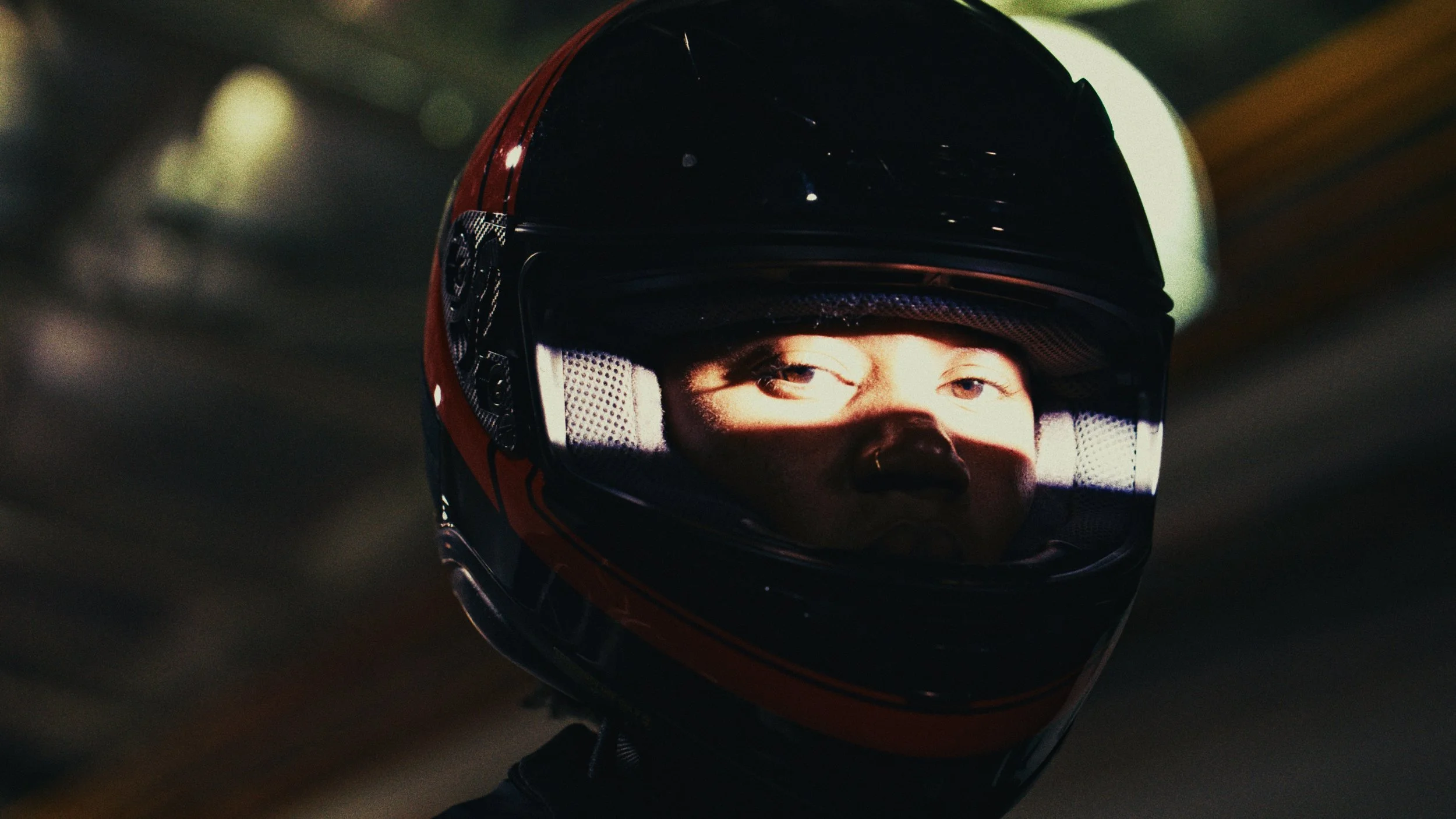 Close-up of a person wearing a Bobsled helmet with a spotlight on their eyes.