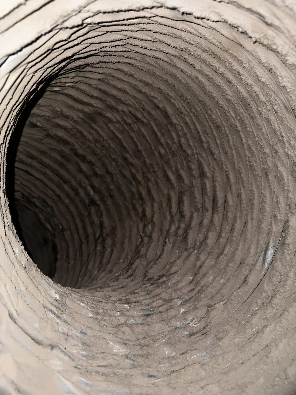 Close-up of a corrugated cardboard tube, showing its ridges and inner hollow.